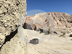 Red SUV in Sand by Arroyo Tapiado Mud Caves in Anza Borrego State Park photo