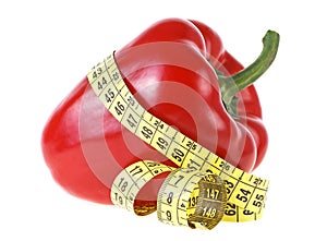 Red sweet bell pepper and yellow measuring tape isolated on white background. Healthy food and diet concept