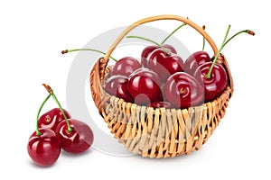 Red sweet cherry in a wicker basket isolated on white background with clipping path and full depth of field