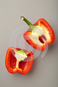 Red sweet pepper on grey background. Space for text. Flat lay. Vertical photo