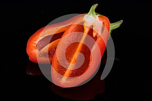 Red sweet peppers isolated on black