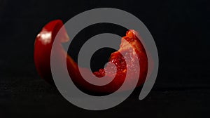 Red sweetpepper on a black background. Close-up.