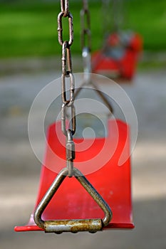 Red Swings Swingset Hanging in a Row for Childhood Fun photo