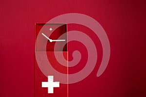 Red Swiss clock on red background