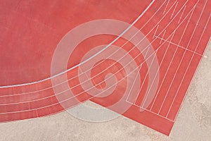 Red synthetic rubber athletic running track on stadium. aerial view