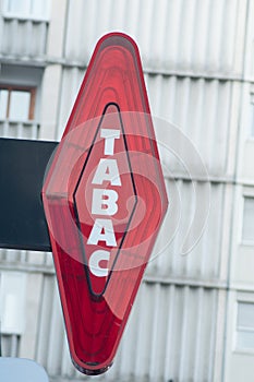 Red tabacco sign with french text tabac, the traduction in english of tobacco