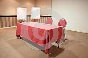 Red table in empty conference room