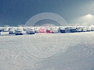 Red taillights in snow covered parking lot