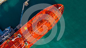 Red tanker ship loading and unloading oil and gas at industrial port, Business import export petrochemical oil and gas by tanker