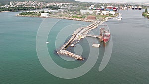 Red tanker ship loading and unloading oil and gas storage at industrial dock port, Business import export petrol and chemical by t