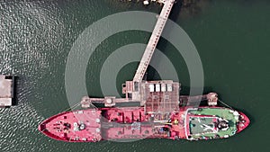 Red tanker ship loading and unloading oil and gas storage at industrial dock port, Business import export petrol and chemical by t