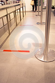 The red tape stick on the floor as a practicing of the Social Distance