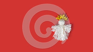 Red tassel Baba Marta symbol Martenitsa on white card. International Martisor day celebrate spring arrival. Greetting