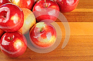 Red tasty apples on wooden table