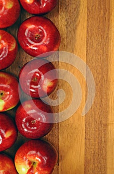 Red tasty apples on wooden table