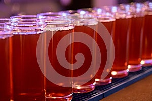 Red drink. Same glasses. Dark background