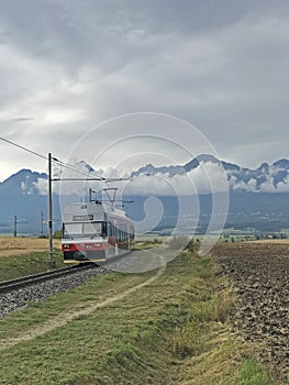 Tatra electric railway train with High Tatras in the backround, Slovakia