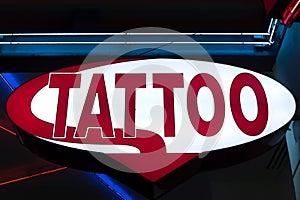 Red Tattoo Sign at Night