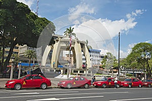 Red taxi cabs wait in line at the Central Park in San Jose, Costa Rica.