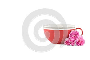Red tea cup and pink carnation flower