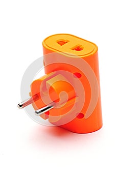 Red tee splitter for connecting electrical plugs to electrical outlets on a white background