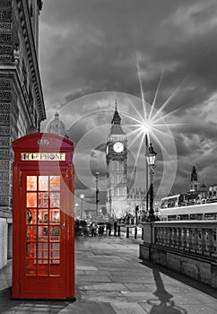 Red telephone booth in front of the Big Ben