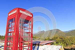 Red telephone booth or public payphone