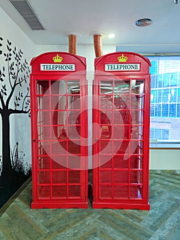 Red telephone booth replica with yellow queen crown logo