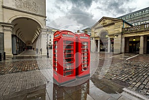 Red Telephone Box at Covent Garden Market on Rainy Day photo