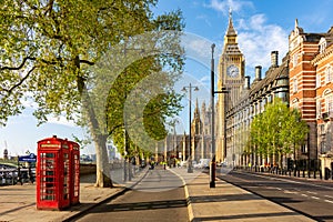 Red telephone boxes on Victoria embankment and Big Ben tower, London, UK