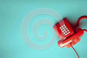 Vintage red telephone on green background