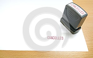 The red text, CANCELLED was stamped with rubber stamp on the white paper