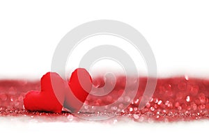 Red textile hearts on glitters