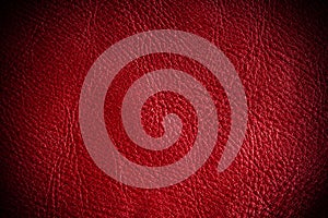 Red textured leather grunge background closeup