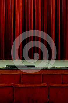 Red theater seats and curtain