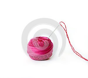 Red thread ball and needle with red thread isolated on white