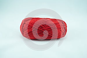 Red thread ball on white background