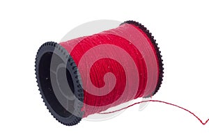 Red thread on black plastic spool