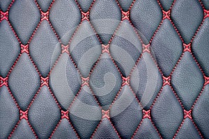 Red thread lines in rhombus pattern on realistic black leather car seat surface