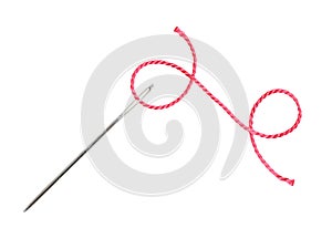 Red thread and needle isolated on white