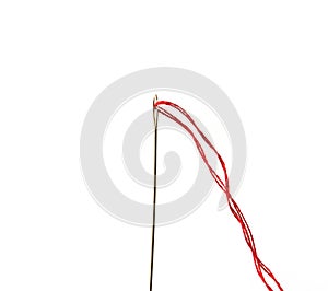 Red thread and needle isolated on white