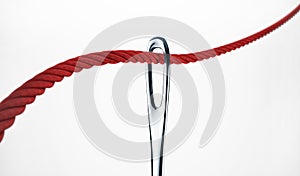 Red thread and a needle isolated on white with clipping path