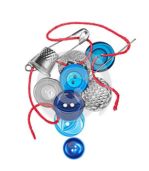 Red thread with needle sews the blue button