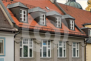 Red tile roof and gabled dormer windows in Munich, Germany