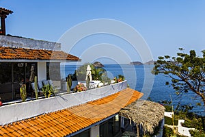 Red tile roof of resort along the shoreline of Ixtapa Bay in Mexico.