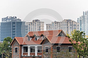 A red tile traditional house and modern skylines in Shanghai, China