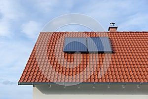 Red tiled roof with solar thermal power plant