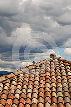 Red Tiled Roof with Storm Clouds