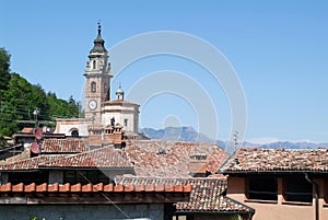 Red tiled roofs and an ancient church in Carona