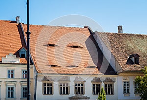 Red tiled roofs with eye-like windows photo